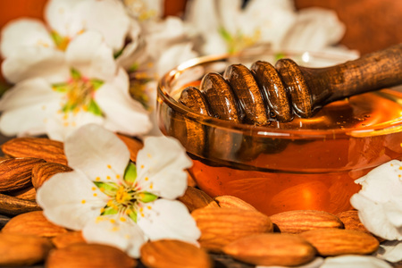 Almond honey, nuts and white flowers closeの写真素材