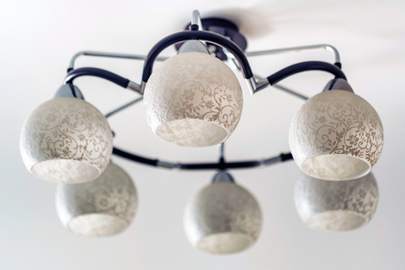 Modern white chandelier on the ceilingの写真素材