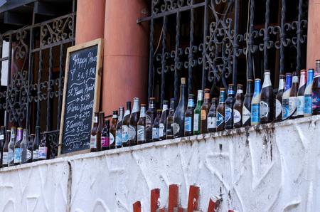 SANTO DOMINGO, DOMINICAN REPUBLIC- OCTOBER 30, 2015: Glass bottles outside pub in Santo Domingoのeditorial素材