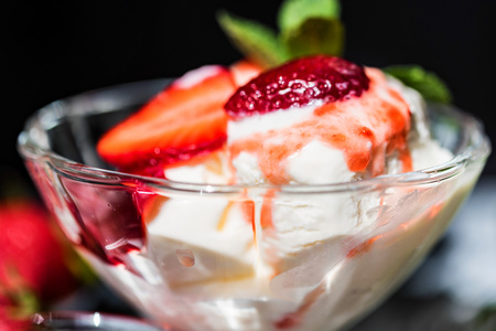 Strawberry ice cream with mint in bowl