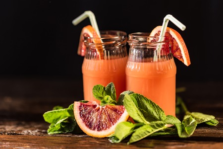 Jars of fresh blood orange juice, selective focusの写真素材