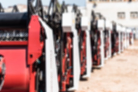 Many new combine harvesters on plant blurred