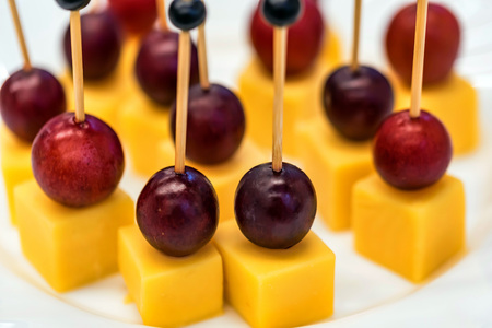 Banquet table with cheese snacks close
