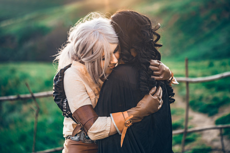 Fantasy cosplay two beautiful girls hug in natureの写真素材