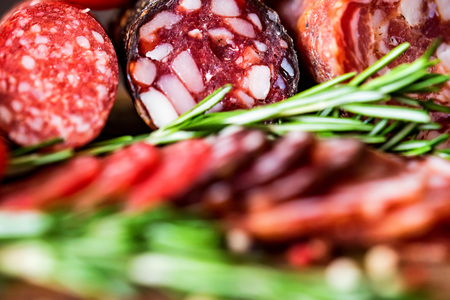 Three types of salami with herbs and peppercornの写真素材