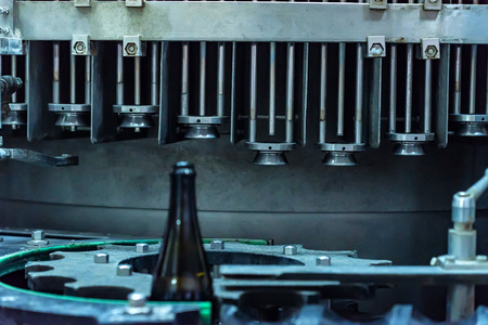 Wine bottle on corking conveyor at wineryの写真素材