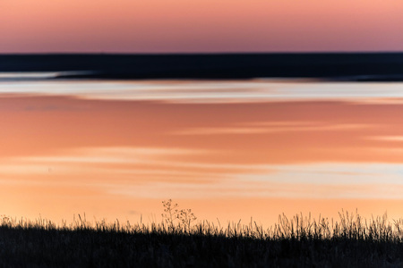 Beautiful sunset over the field and lakeの写真素材