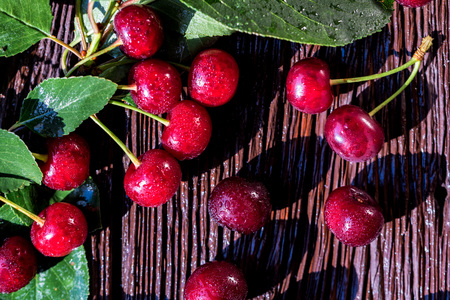 Sweet ripe cherries on wooden background top view