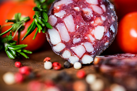Tasty salami with tomatoes and peppercorn closeの写真素材