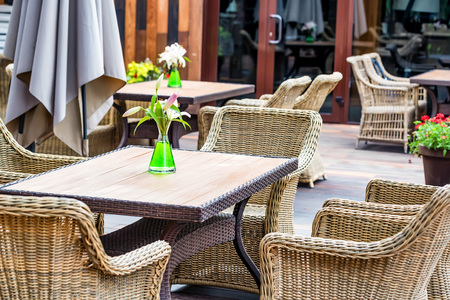 Outdoor restaurant interior with wicker chairsの写真素材