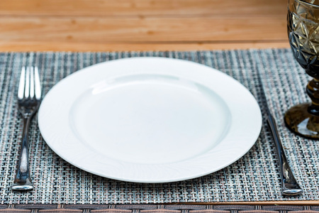 Table setting with fork, knife, plate and glassの写真素材