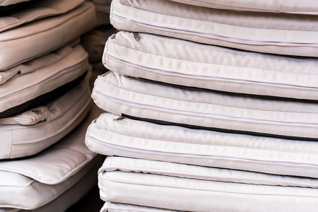 Stack of white seat pads in restaurantの写真素材