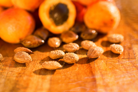 Fresh apricots and seeds on wooden surfaceの写真素材