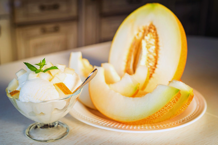 Vanilla ice cream with pieces of fresh melon closeの写真素材