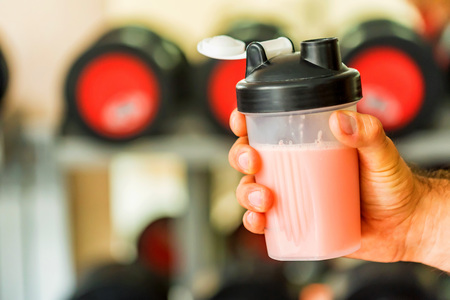 Hand holds plastic shaker with protein cocktailの写真素材