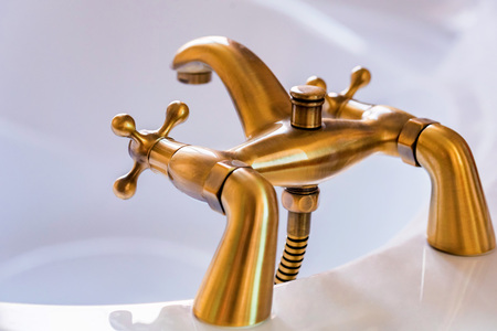 Modern brass or bronze tap for bathroomの写真素材