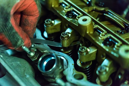 Maintenance check and adjust valve lash in car engineの写真素材