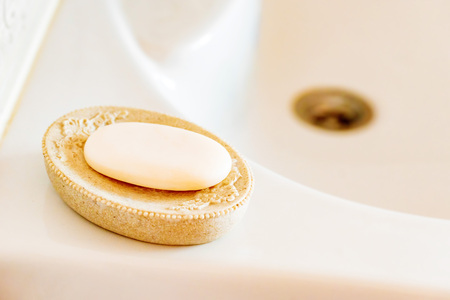Soap on a dish over ceramic sink