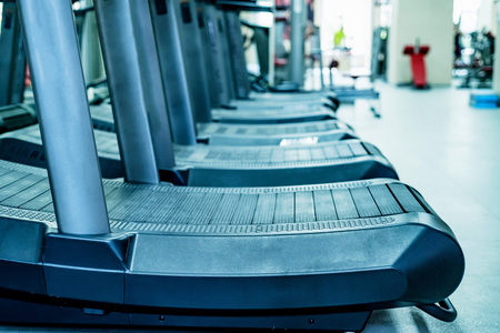 Empty treadmills set in gym interior closeの写真素材