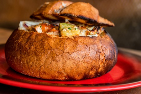 Meat stew served in bread bowl on plate