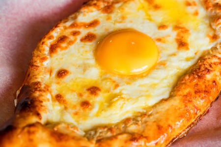 Ajarian khachapuri Georgian cheese pie with egg close