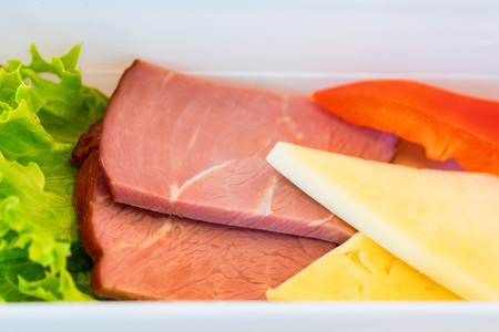 Plastic bowl with sliced food for airplane meal close