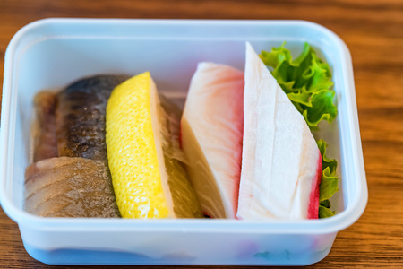 Plastic bowl with sliced food for airplane meal closeの写真素材