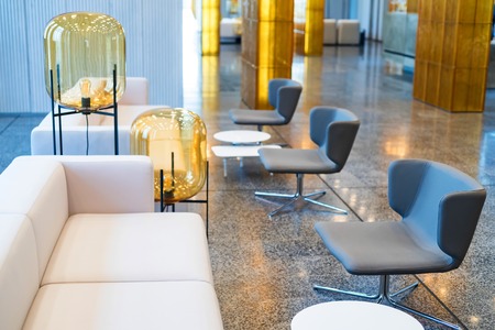 Office waiting area interior with white sofas