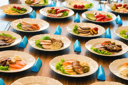Close up table with plates of different airplane meals variants at presentation