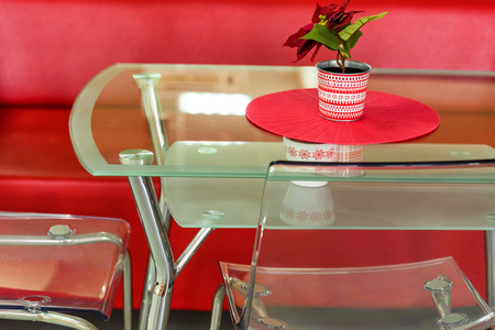 Red sofa and transparent table with flower in waiting area