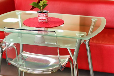 Red sofa and transparent table with flower in waiting areaの写真素材