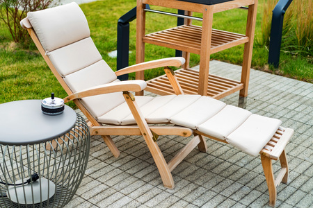 Outdoor patio with wooden armchairs and table