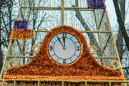 Cristmas clock outdoors decorated with tinsel close