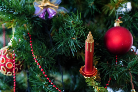 Colorful Christmas decorations balls and candle on treeの写真素材