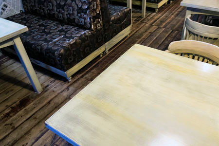 White wooden table and black sofa in restaurant