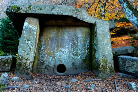 Ancient stone dolmen in the autumn forestの写真素材