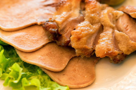 Different kinds of cooked meat and green salad on plate closeの写真素材