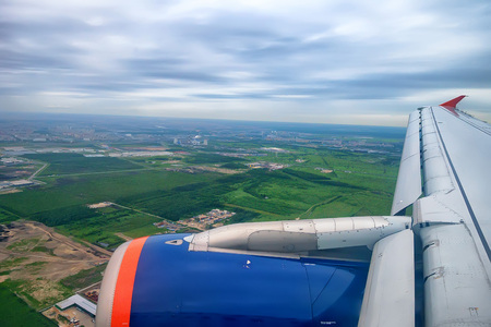 Skyscape of green lowland viewed from airplane