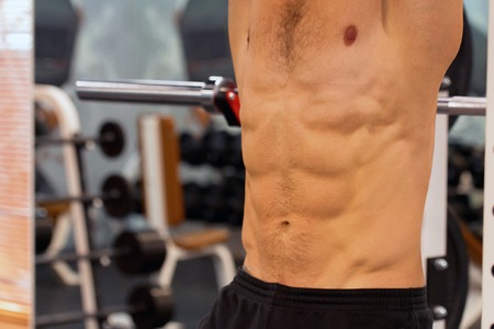 Close-up torso of male athlete at gym