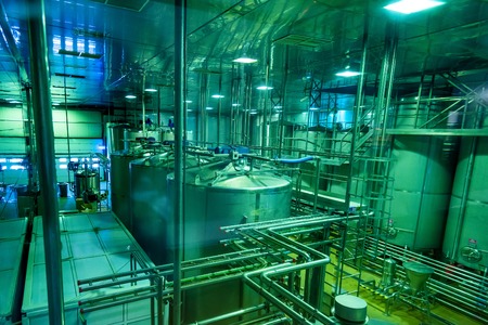Industrial interior of soft drinks factory with tubes