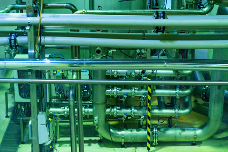 Industrial interior of soft drinks factory with tubes