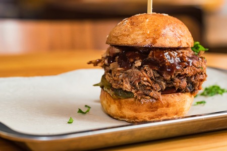 Close up tasty burger with minced meat served on trayの写真素材