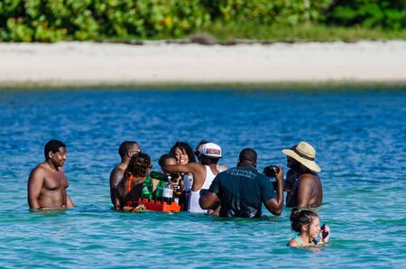 HIGUEY, DOMINICAN REPUBLIC - OCTOBER 29, 2015: Group of people party in waterのeditorial素材