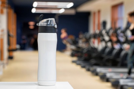 Plastic bottle or cup with fitness drink close upの写真素材
