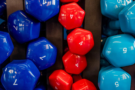 Stand with colorful dumbbells in modern gymの写真素材