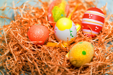 Several colorful Easter eggs in nest close