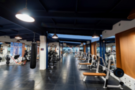 Blurred view of new fitness machines in modern gym interior