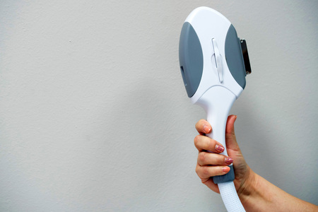 Hand of doctor iholds laser cosmetology deviceの写真素材