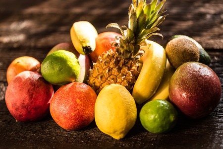 Studio shot of various exotic fruit on woodの写真素材