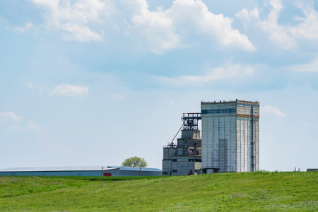 White grain elevator in green steppe nature